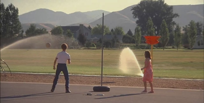 Man and a woman playing with water jets