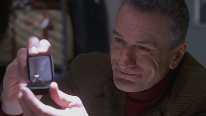 Man proposing to a woman with a small box and a ring 