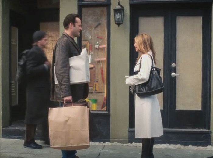 Man and a woman standing at the street talking and looking each other