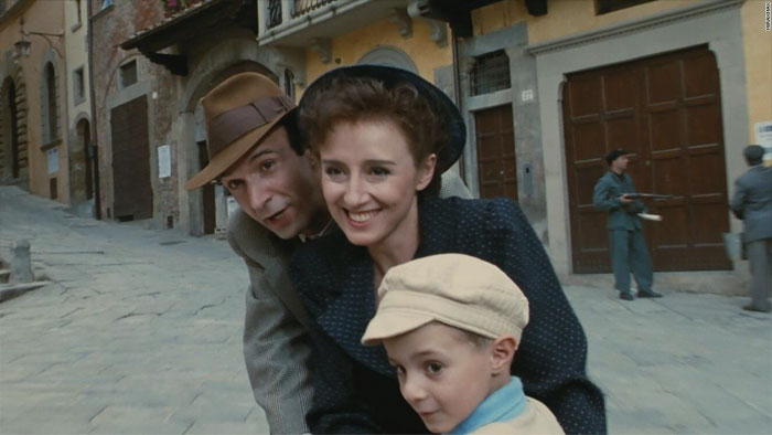 Mom dad and a kid posing for a picture 