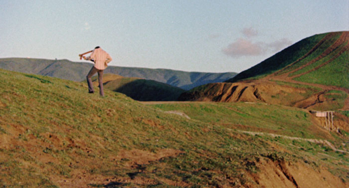 Man playing a guitar on a mountain 
