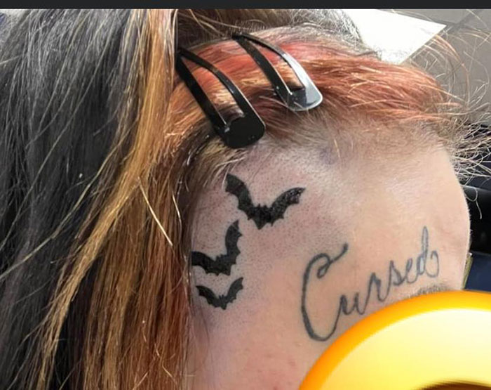 A tattoo with bats and the word "Cursed" on a person's head, highlighted in a discussion about bad tattoos.