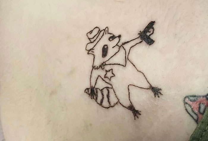 Poorly drawn tattoo of a cartoon raccoon, highlighting bad tattoo mistakes.