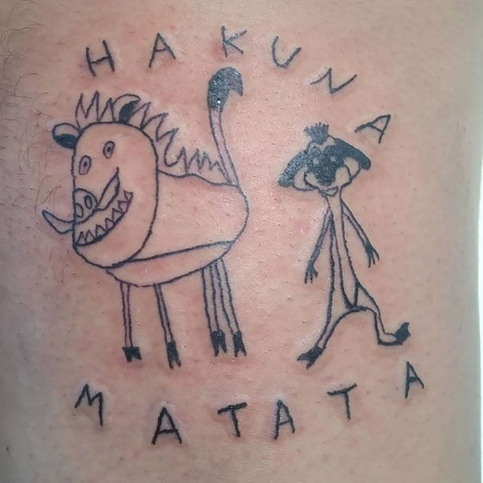 Bad tattoo of cartoon characters with text "Hakuna Matata" drawn on skin.