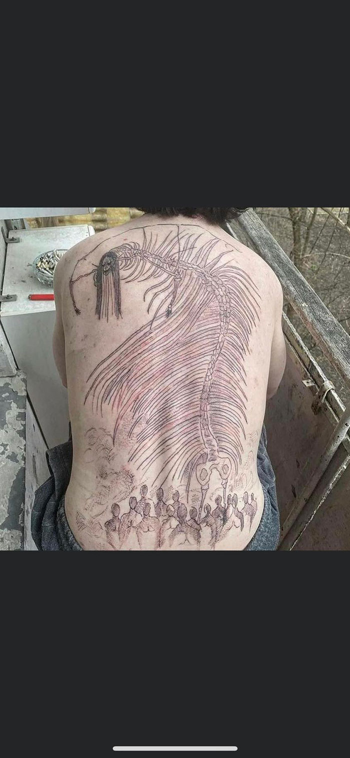Back tattoo depicting a surreal scene with a skeletal figure and abstract people, showcasing bad tattoos.