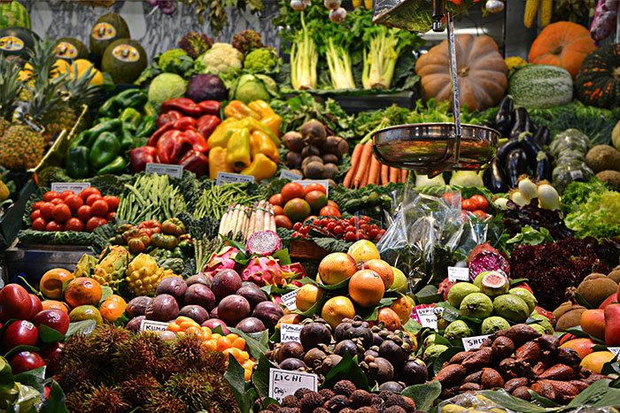 Colorful vegetables on display at a vibrant farmer's market, featuring fresh produce for a perfect "me time" activity.