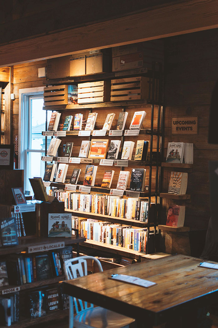 Bookshelf filled with various books for relaxing "me time" activities.