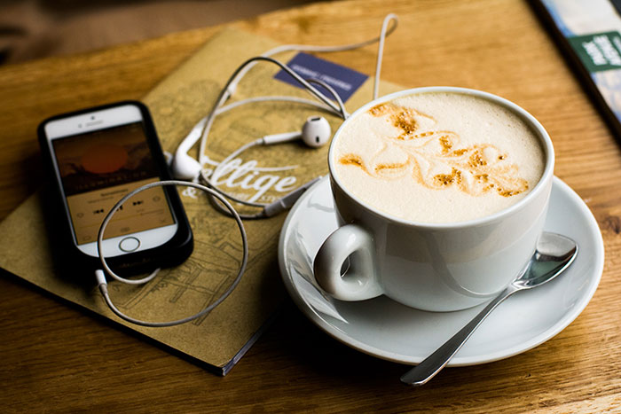 Coffee cup and phone with earphones for relaxing me time.