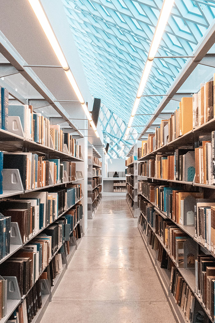 Library aisle filled with books, perfect for enjoying some me time with a good book.