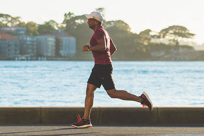 Person running alone near a waterfront, enjoying some “me time.”