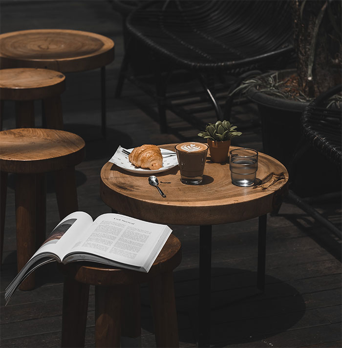 Coffee and croissant on a table, perfect for a relaxing "me time" moment.