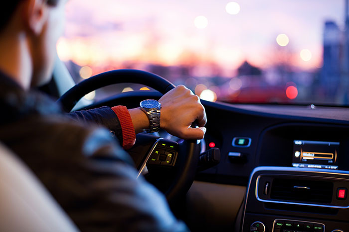 Person enjoying some me time while driving a car at sunset, focusing on self-care and relaxation.