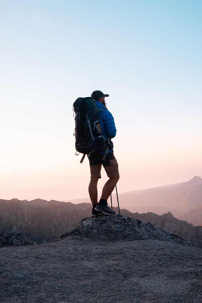 Person hiking on a mountain, enjoying nature and solitude during "me time."