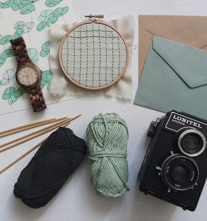 Threads and letters on a table for solo crafting and creativity.