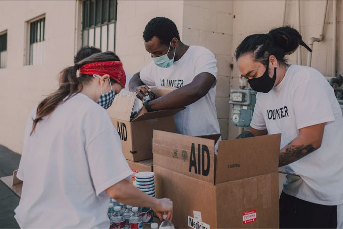 Volunteers putting things in a box 