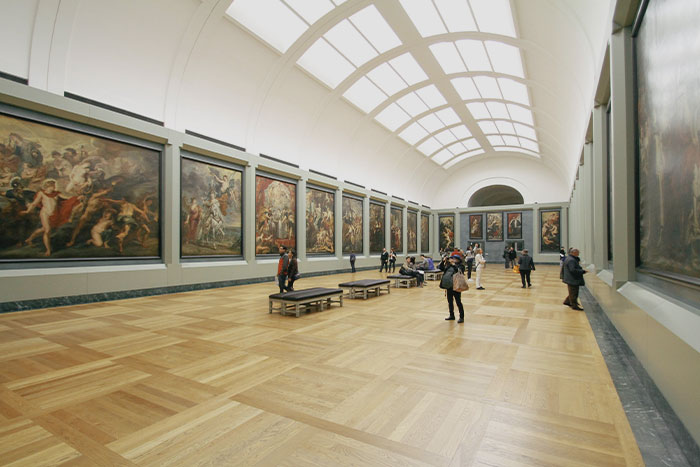 Multiple people in a museum looking at art 