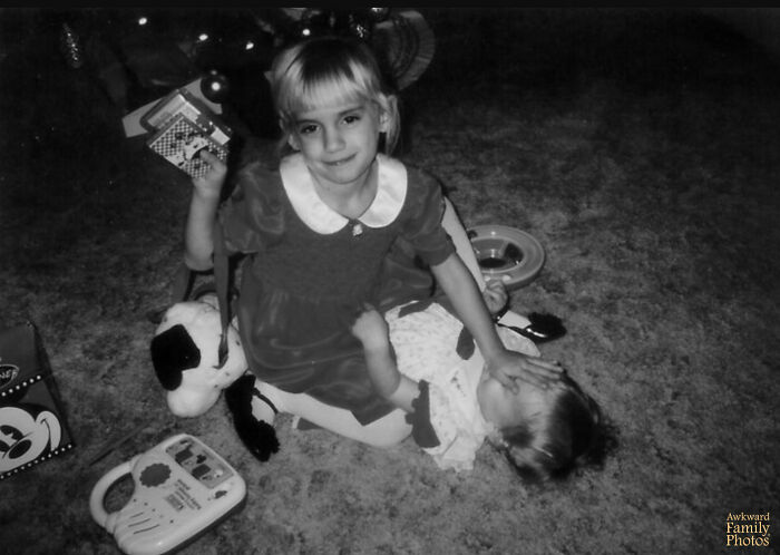 This Is A Photo Of My Younger Sister And I On Christmas In 1996. I’m The One With The Triumphant Look On My Face Holding The Cards And Mashing My Hand In My Sister’s Face