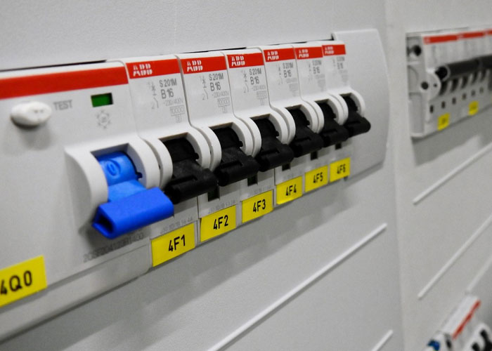 Electrical circuit breakers inside a home panel, illustrating homeowning safety and maintenance tips for homeowners.