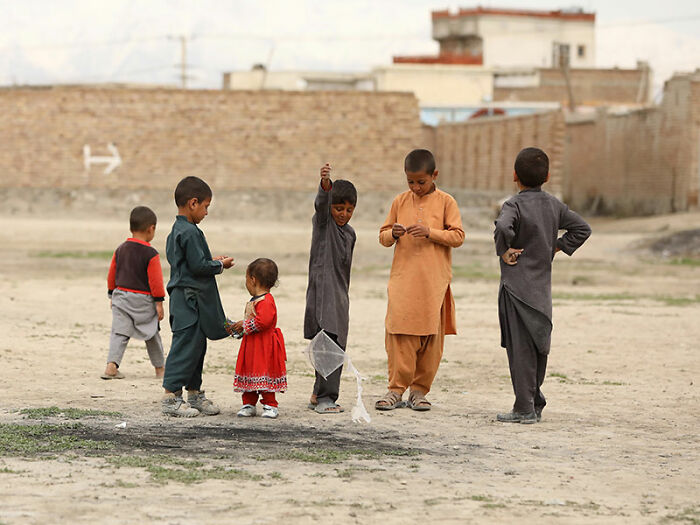 Children playing outdoors in Afghanistan, capturing everyday life and culture while traveling in Afghanistan.