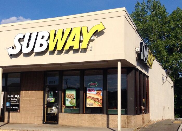 Subway restaurant exterior with signage on a sunny day, featured as a never again brand or store discussion topic.