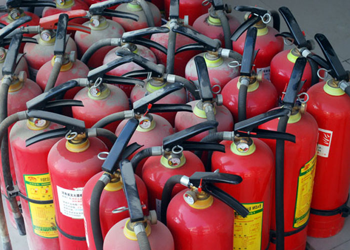 Multiple red fire extinguishers grouped together, symbolizing safety advice from dads about homeowning.