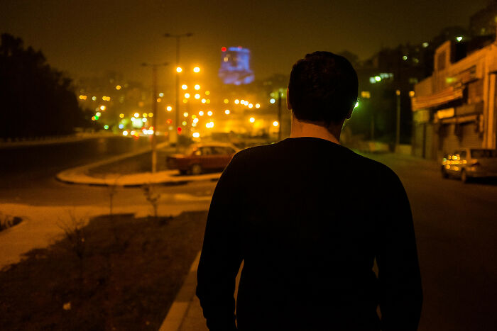 man walking down the street wearing black shirt 