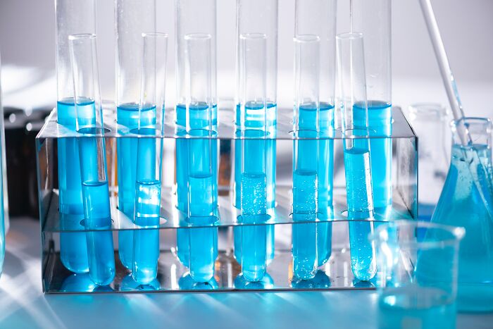 Test tubes filled with blue liquid in a lab setting, illustrating basic science facts and common knowledge misconceptions.