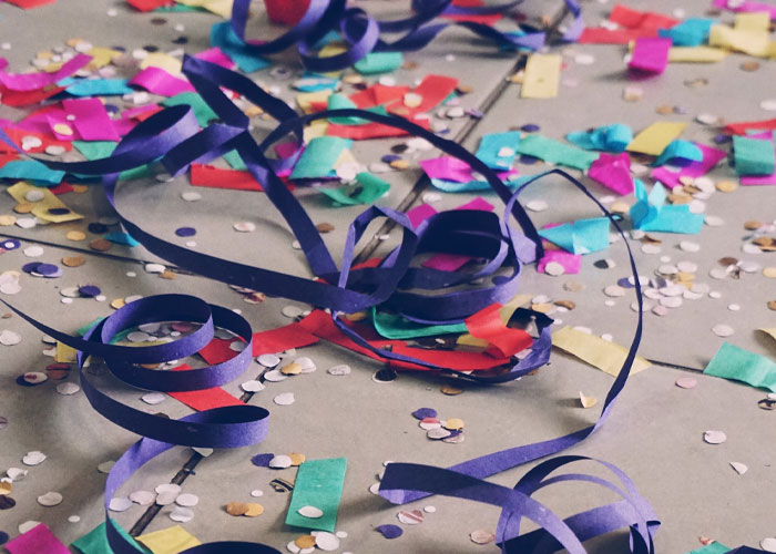 Colorful party streamers and confetti scattered on the ground, hinting at a disturbing work event experience