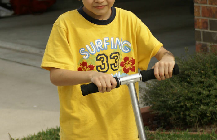 boy wearing yellow t-shirt 