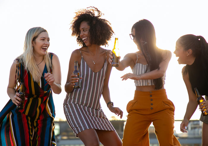 four girls dancing and drinking
