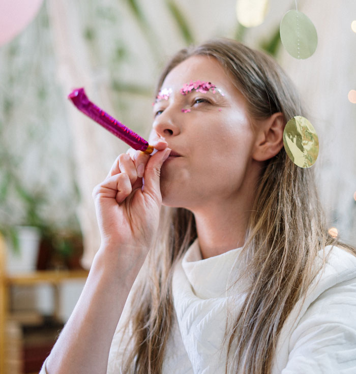 woman with party blower in her mouth