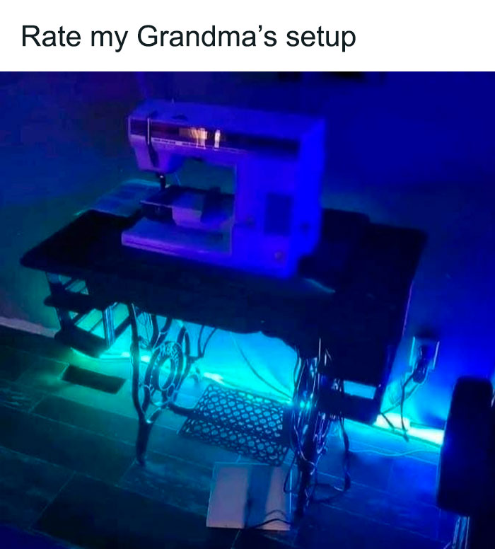 Cursed gaming setup featuring an old sewing machine on a desk with blue LED lighting in a dark room.