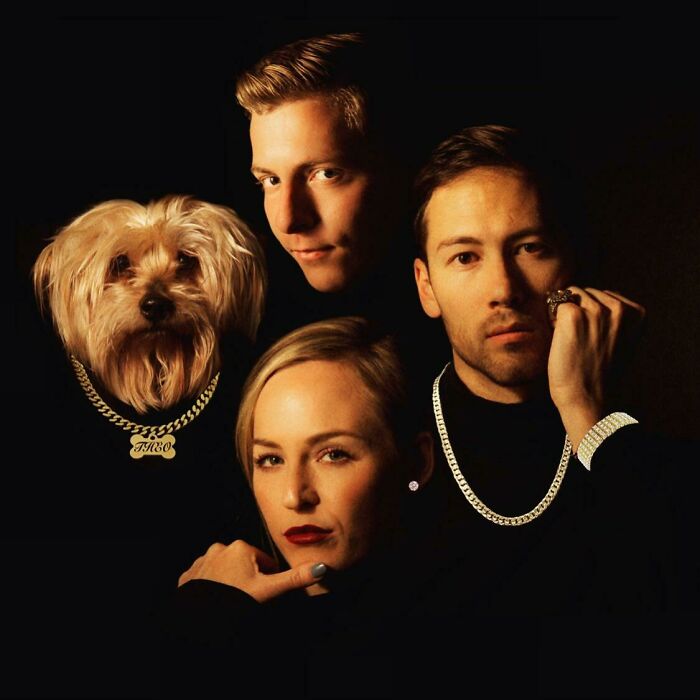 Funny Christmas card with three people and a dog styled in a retro portrait, wearing gold chains and dark attire.