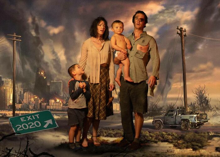 Family posing in a humorous Christmas card with a post-apocalyptic theme, holding children with a burnt city in the background.