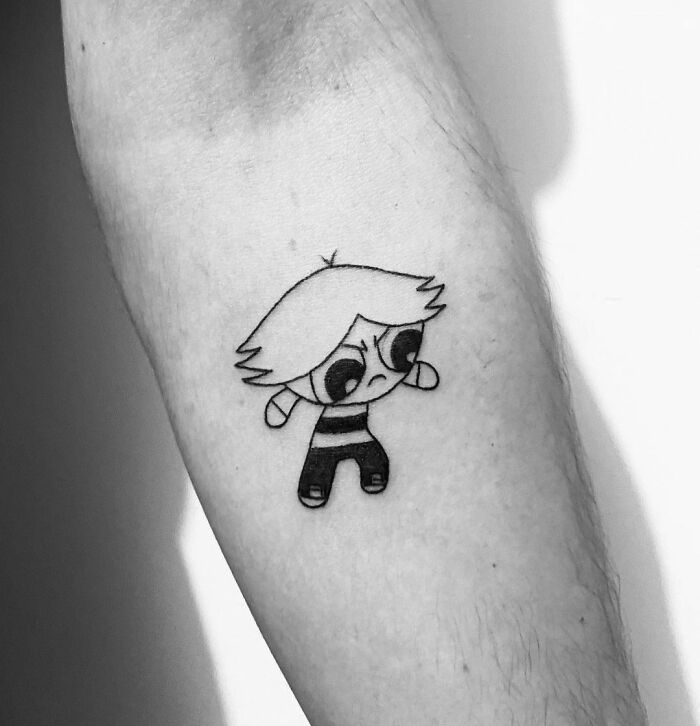 Black and white cartoon tattoo of a character from a favorite animated show on a person's arm.