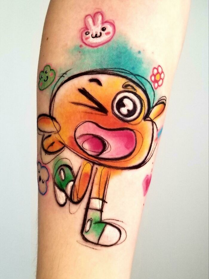 Colorful cartoon tattoo featuring a playful character, inspired by childhood favorites, on an arm with bright accents.