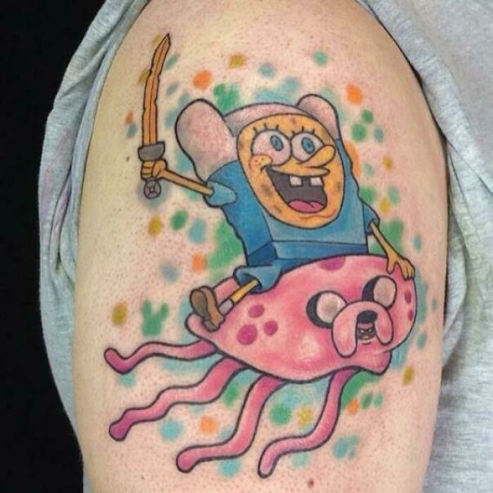 Colorful cartoon tattoo featuring a hybrid SpongeBob character with a sword, sitting on a jellyfish-like creature.