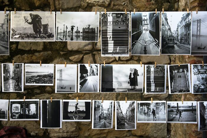 Black and white photos displayed on a stone wall, showcasing cool photography ideas for New Year's Eve celebrations.