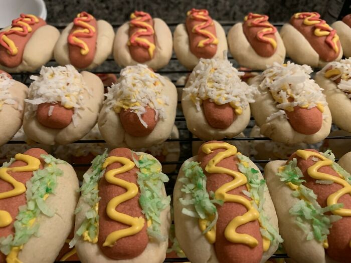 Christmas cookies shaped like hot dogs with icing and coconut toppings, showcasing a sense of humor.
