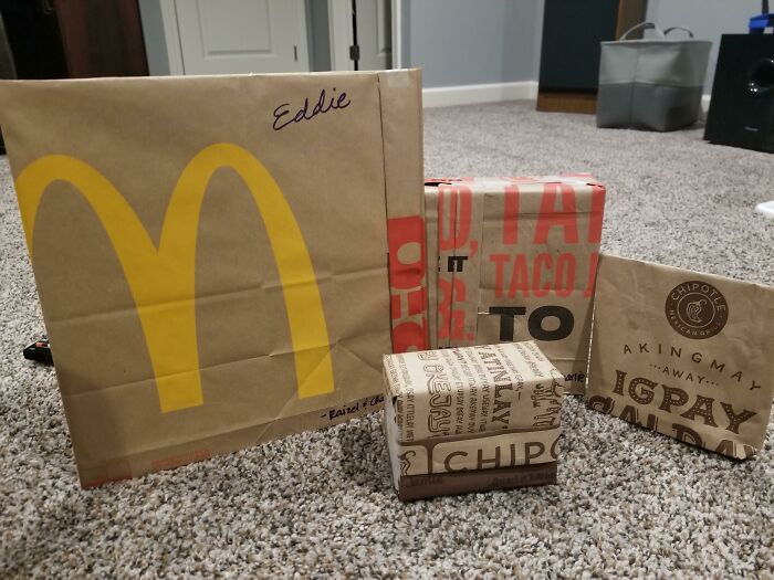 Christmas gifts humorously wrapped in fast-food bags, adding amusing flair to the festive season.