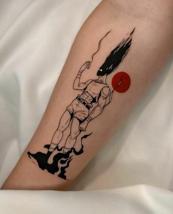 Arm with a cartoon tattoo of a muscular figure with a dark faceless head and red balloon, inspired by animated shows.