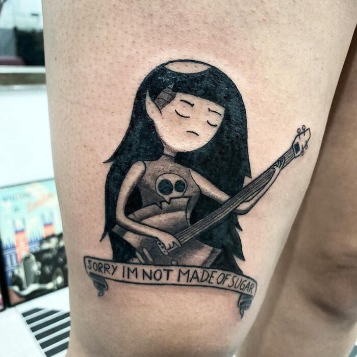 Tattoo of Marceline from Adventure Time playing guitar, capturing cartoon nostalgia.
