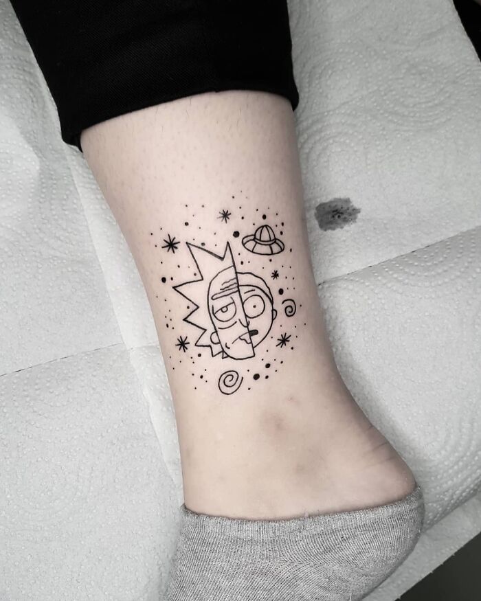 Cartoon tattoo of Rick and Morty characters in space theme on a person's ankle.