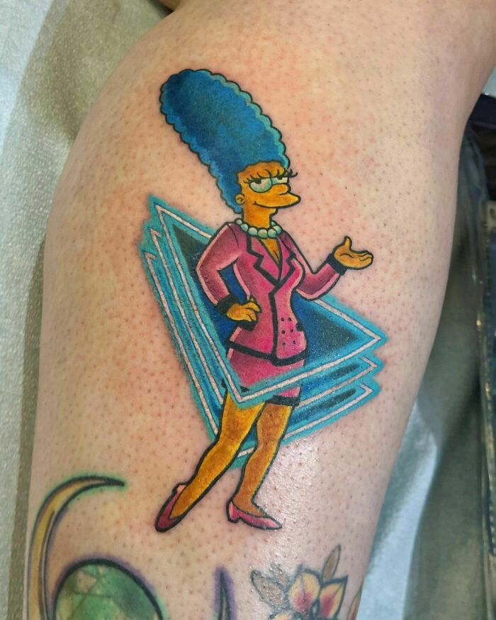 Cartoon tattoo of Marge from "The Simpsons" wearing a pink suit, showcasing nostalgic charm.