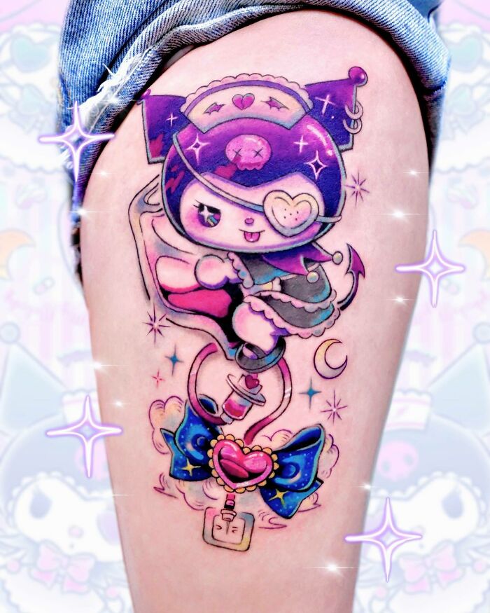 Colorful cartoon tattoo of a playful character with a heart eyepatch, evoking childhood's favorites on a person's arm.