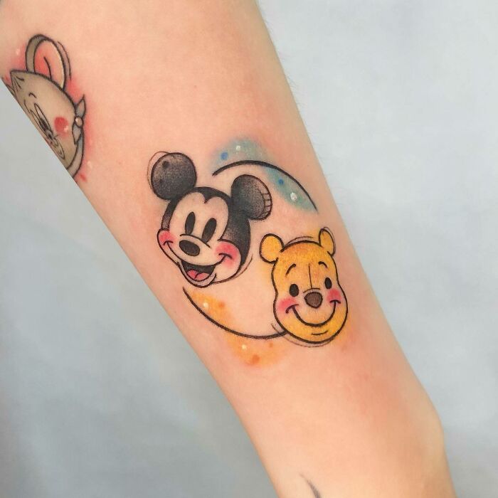 Cartoon tattoo featuring popular childhood characters on forearm.