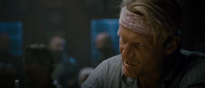 Man wearing a headband sitting in a dimly lit room, referencing Easter eggs and hidden details from popular films.