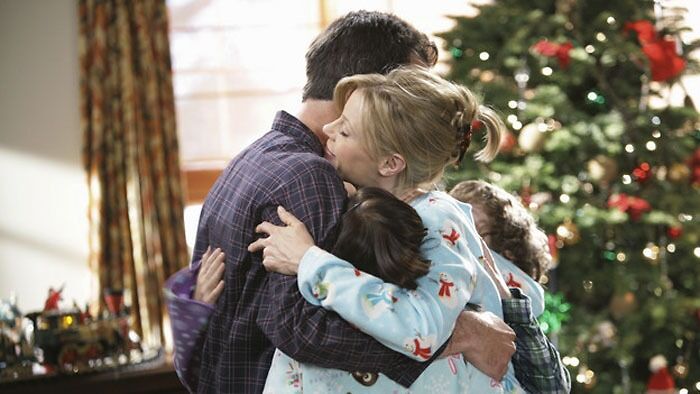 The Dunphy family hugging 