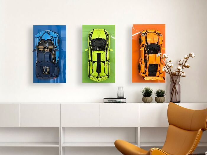 Three incredible LEGO builds of cars in blue, green, and orange displayed as wall art in a modern living space.