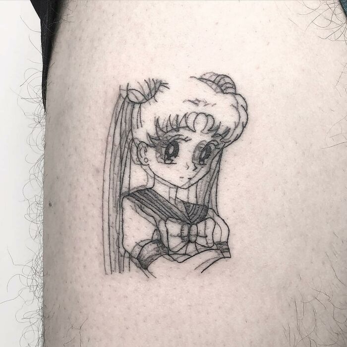 Anime-inspired trippy tattoo featuring a character in a sailor outfit with long hair.